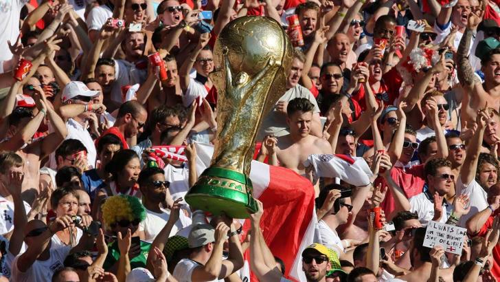 England fans at the World Cup holding a giant Jules Rimet trophy 